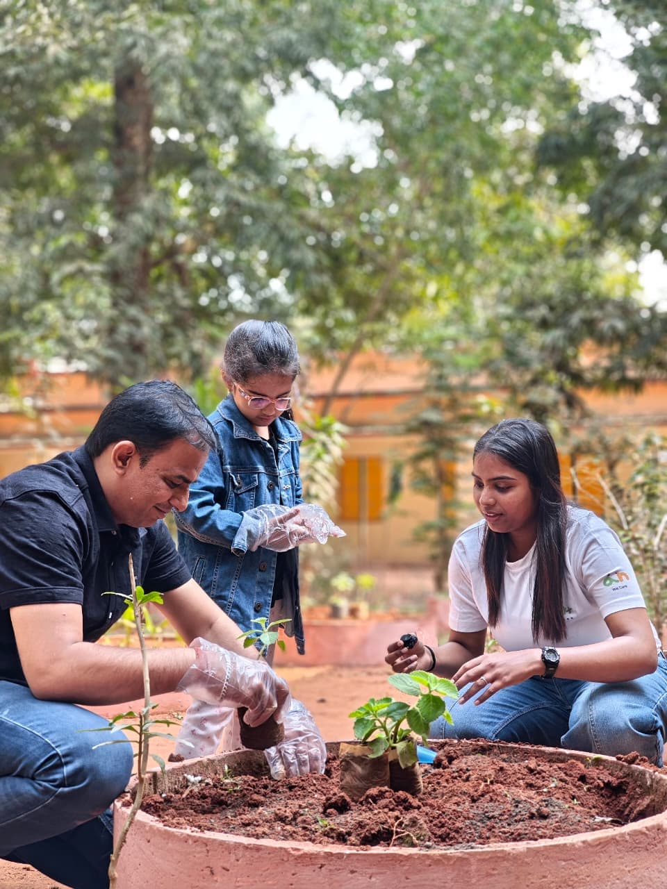 Volunteers planting saplings together as part of a CSR initiative