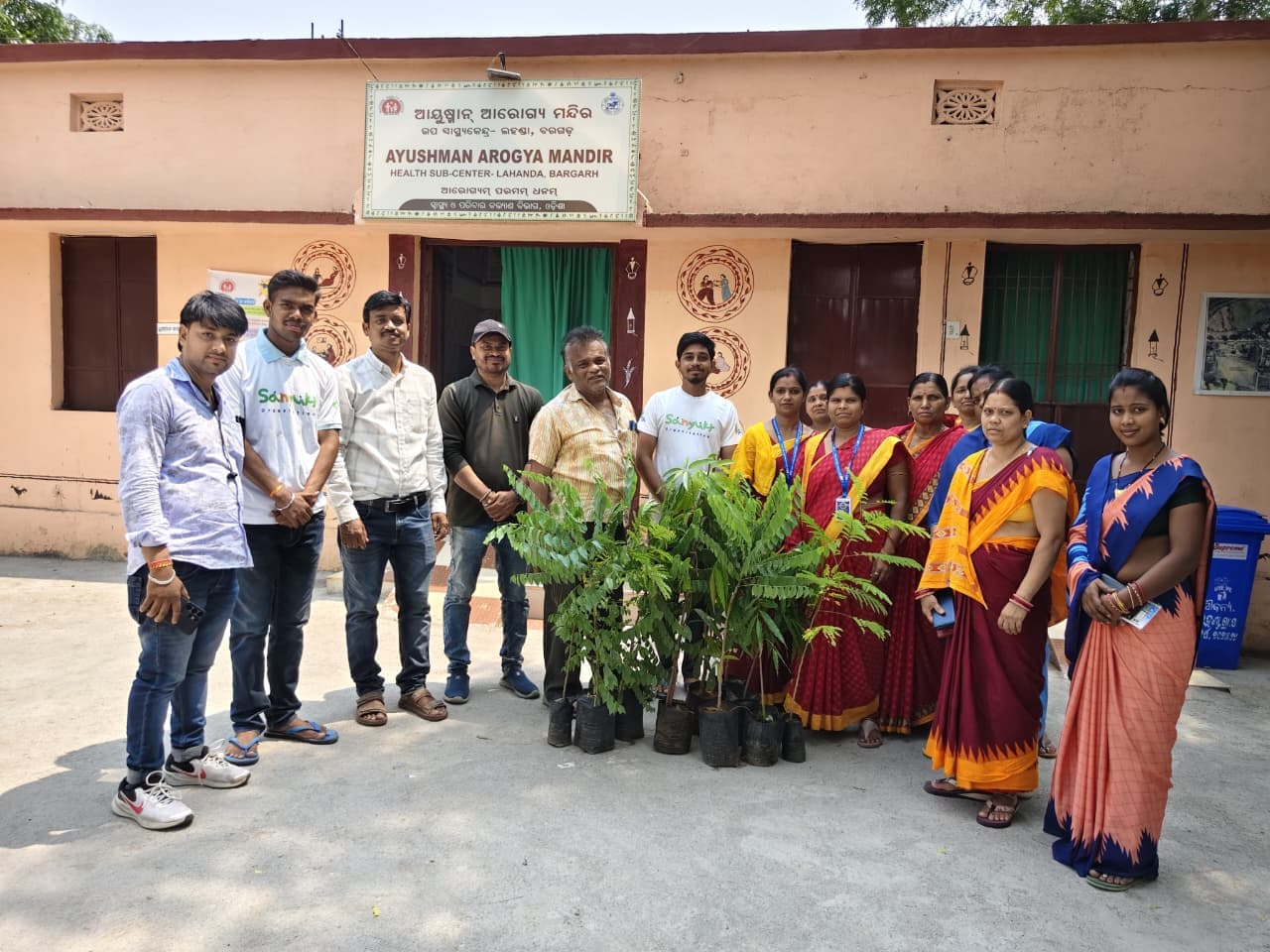 Sanyukt team and community members outside a health sub-center after a plantation drive