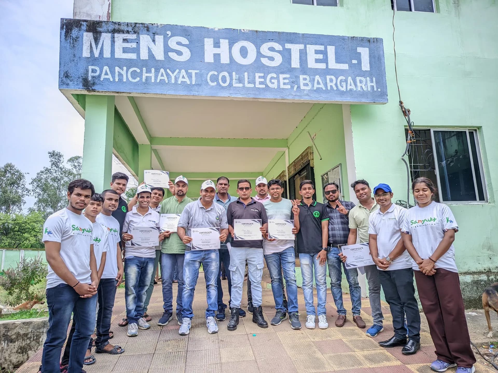 Sanyukt team members and corporate partners holding certificates of appreciation during a community partnership event in Odisha