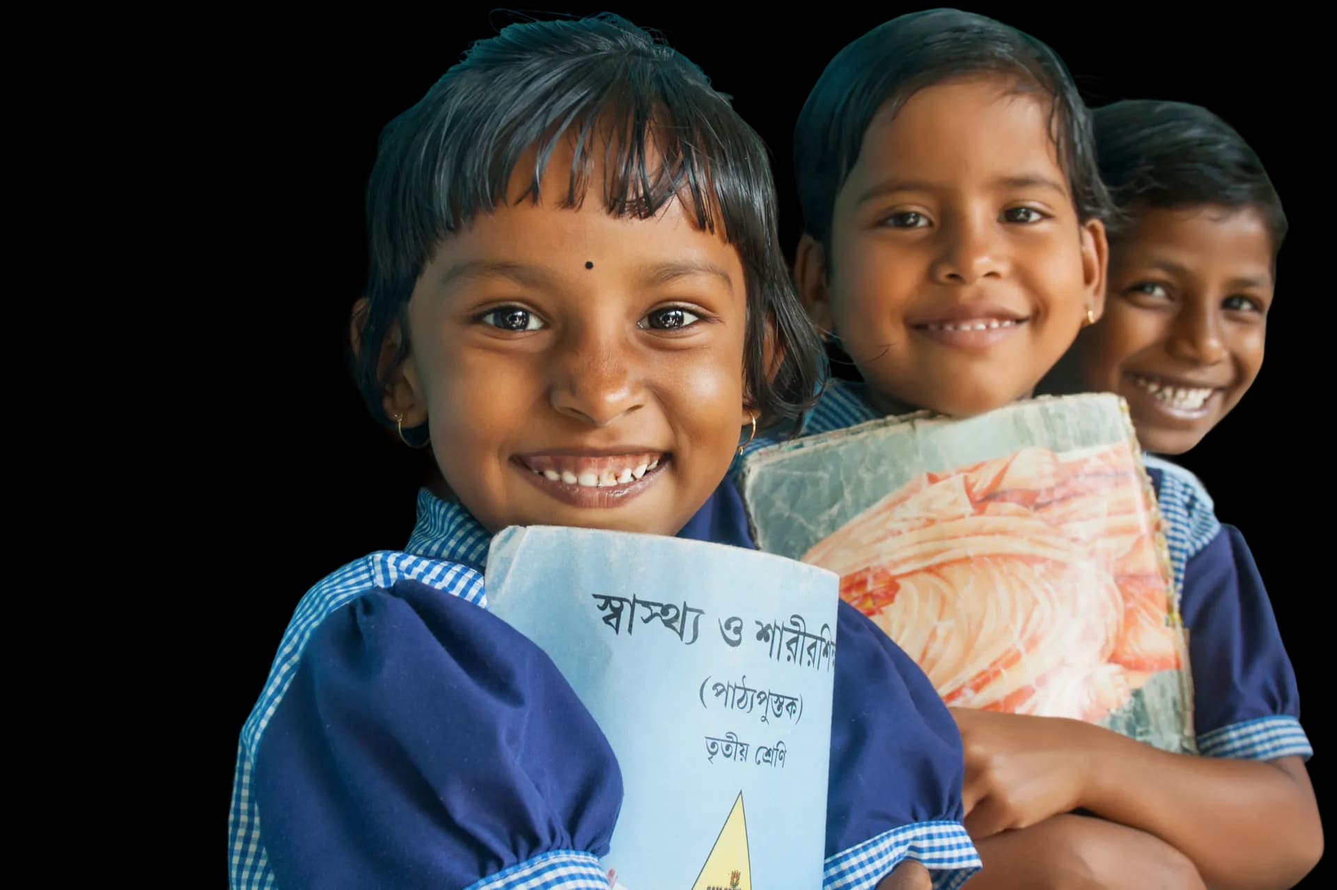 Black-and-white portrait of three smiling children supported by Sanyukt programs